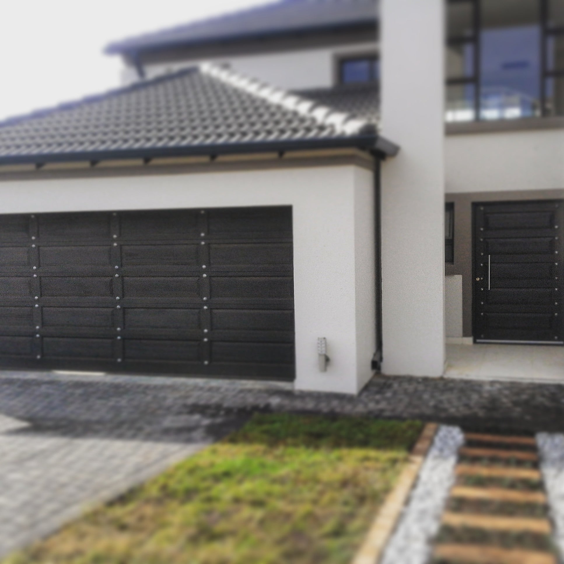 Double garage and front door featuring NW/93DD CH chrome studs 