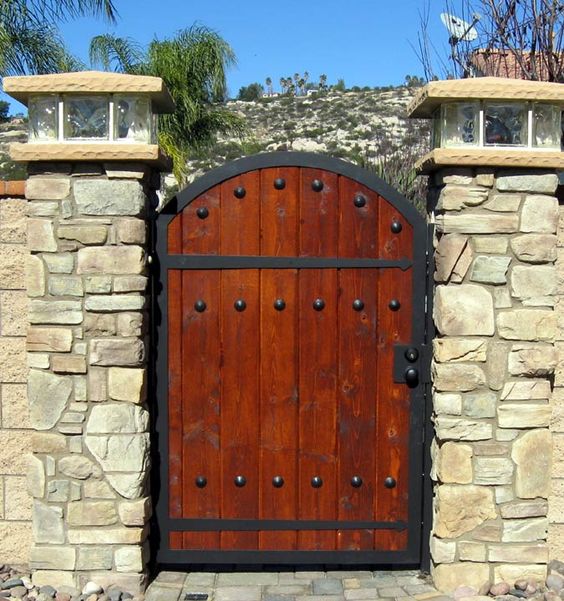 Decorative hardware used on a wooden entrance gate. Simple to install, great for us on the interior as well as the exterior of the home. Choose from a wide variety, all of which are handmade and hand painted. Shop online at www.doorstuds.co.za