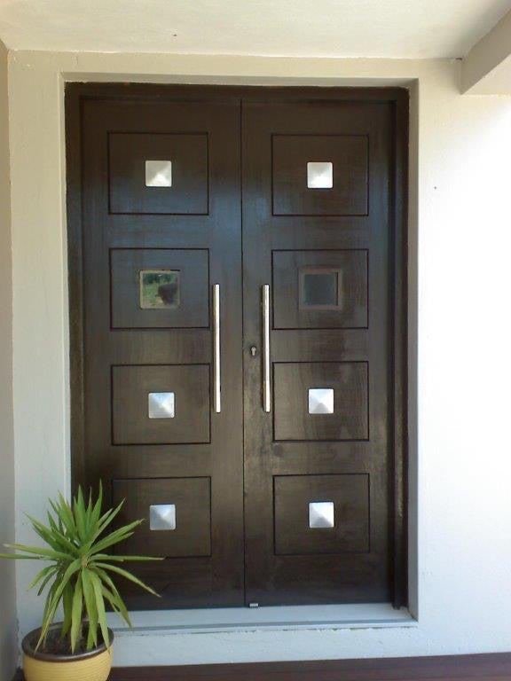 Front door with custom NW/105DD decor hardware square studs to give a gothic / rustic look. Decorative hardware made easy 