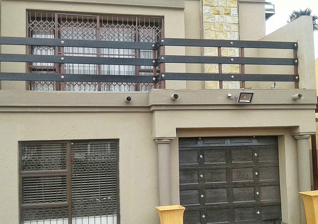 Gothic chrome square decor studs on a garage door and balustrade