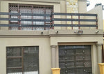 Gothic chrome square decor studs on a garage door and balustrade