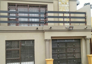 Gothic chrome square decor studs on a garage door and balustrade